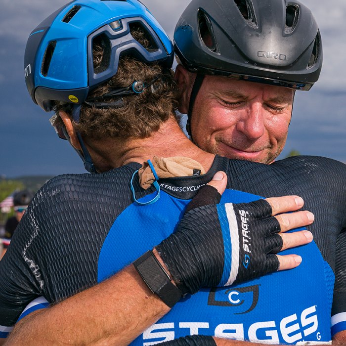 Stages employees embrace after setting a cycling record